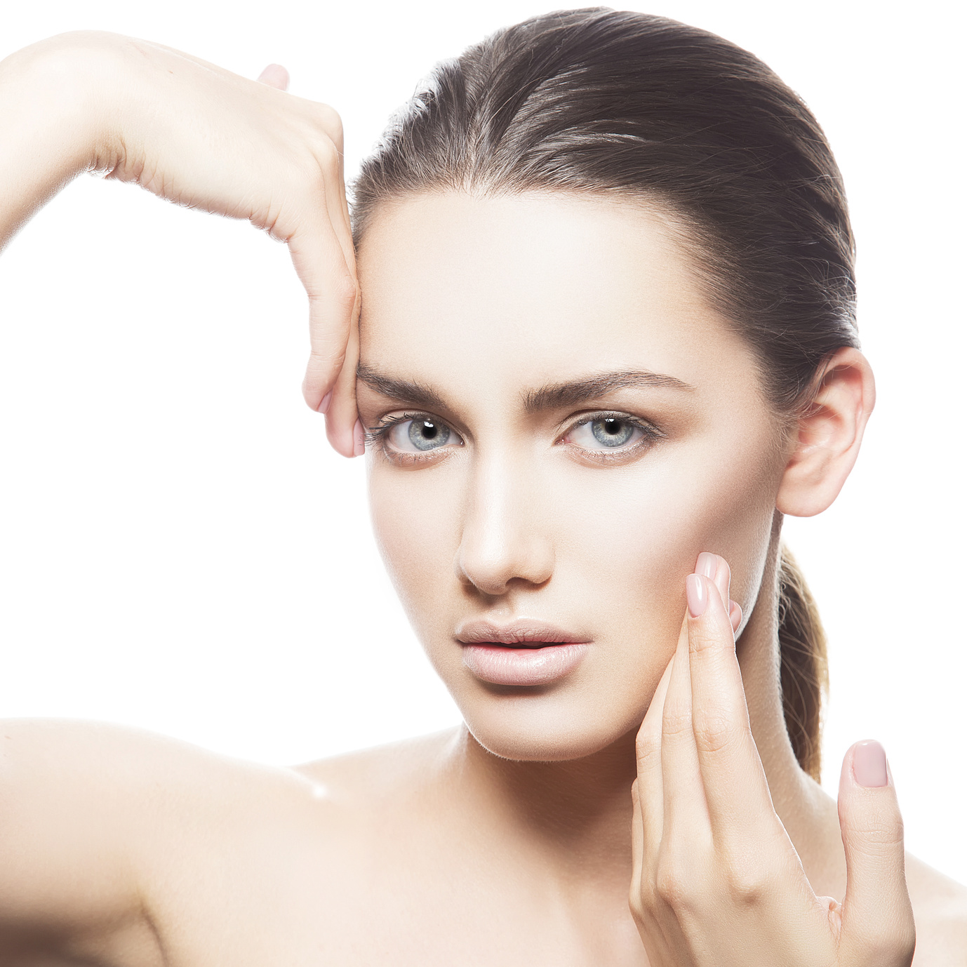 Beautiful young teen woman face with healthy clean skin, natural make up and blue eyes isolated on white background. Hold hands on head.